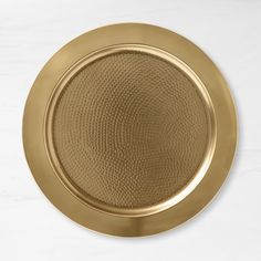 a gold plate sitting on top of a white counter