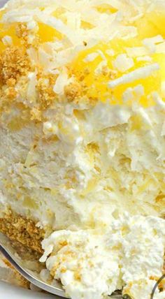 a close up of a cake on a plate with a fork in the foreground