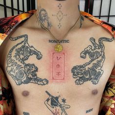 a man with tattoos on his chest has a chinese zodiac sign