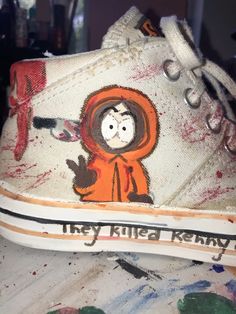 a pair of painted shoes with an image of a cartoon character on the soles