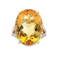 Adorn your finger with opulent elegance with this 14 karat yellow gold ring featuring a breathtaking citrine gemstone weighing an impressive 18.39 carats. The vibrant citrine commands attention with its warm golden hues, radiating beauty and sophistication. Embellishing the sides of the ring are 1/4 carat in total of dazzling diamonds, adding a touch of sparkle and glamour to the piece. This stunning ring is a true statement of luxury and style, perfect for adding a bold accent to any ensemble. Luxury Yellow Gold Topaz Ring With Gemstone Accents, Luxury Yellow Gold Citrine Diamond Ring, Luxury Citrine Diamond Ring In Yellow Gold, Luxury Yellow Topaz Ring With Diamond Accents, Luxury Yellow Gold Topaz Ring With Diamond Accents, Luxury Citrine Topaz Ring With Gemstone Accents, Formal Citrine Rings With Brilliant Cut, Formal Citrine Diamond Ring With Center Stone, Luxury Brilliant Cut Citrine Diamond Ring