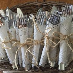 a basket filled with silverware on top of a wooden table