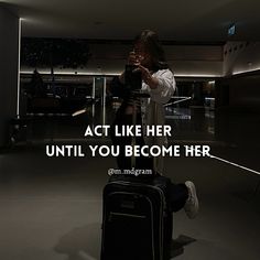 a woman sitting on top of a chair next to a luggage bag with the caption act like her until you become her