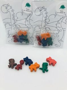 small dinosaur erasers in plastic bags on a table