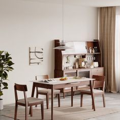 a dining room table and chairs in front of a window