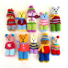 several knitted teddy bears are arranged in different colors and sizes on a white surface