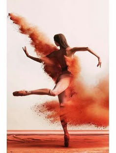 a woman is dancing with dust in the air