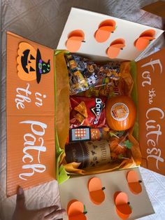 an orange and white box filled with halloween treats