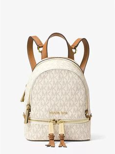 You will receive  an Authentic, New Michael Kors Rhea Mini Logo Backpack in Vanilla/acorn. Convertible: Backpack/ Shoulder/ Sling bag/ Handbag all in one with Michael Kors Dust bag! We will ship your order next business day on cleared payment  or Same business day whenever possible! New with tags • Backpack • Logo-print canvas • 69% coated canvas/17% polyester/13% cotton/1% polyurethane • Gold-tone hardware • 6.25" W X 7.5" H X 2.75" D • Handle drop: 1" • Exterior details: 2 front zip compartments • Interior details: back slip pocket, front slip pocket • Lining: 100% polyester • Zip fastening • Dust bag  included Item ships in 1 business day or same day whenever possible We will ship your order next business day on cleared payment.  When we are able, we will try to ship the same day. We al Michael Kors Backpack, Mini Mochila, Cheap Purses, Mini Logo, Mini Logos, Handbags Affordable, Cheap Handbags, Cute Backpacks, Small Backpack