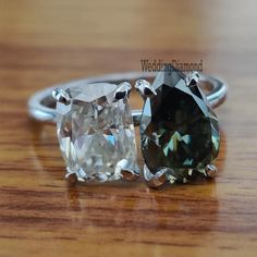 two different colored diamonds sitting on top of a wooden table