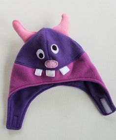 a purple and pink hat with horns on it