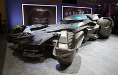 the batmobile is on display in front of some pictures and posters at an exhibit