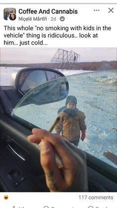 someone taking a selfie in the side mirror of their car while driving on ice