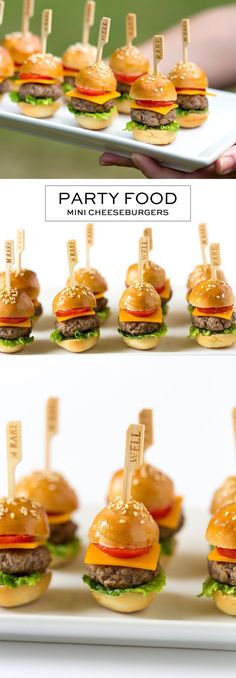 mini cheeseburgers are arranged on a platter with toothpicks stuck in them