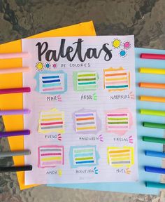 a bunch of colored pencils sitting on top of a piece of paper with the word paetos written in it