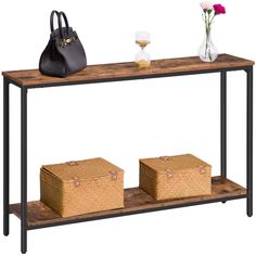 a wooden table with two baskets on it and a handbag next to the shelf