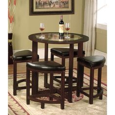 a table with three stools and a wine bottle