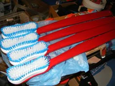 red and white toothbrushes sitting on top of each other in plastic wrappers