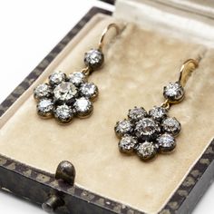 The Natalie earrings are inspired by the Victorian style. They center 2 old mine cut diamonds of K color and SI1 clarity that weigh 1.10ctw. The center stones are surrounded by 16 old mine cut diamonds of J/K color and VS2-SI1 clarity that weigh 2.70ctw. Earring measurement: 22mm by 14mm by 4mm Total weight: 5.0 grams / 3.2 dwt Antique Diamond Earrings, Gothic Accessories, Antique Diamond, Victorian Jewelry, Contemporary Jewelry, Victorian Style, Victorian Fashion, Gold And Silver, Diamond Earrings