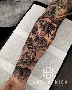 a man's arm with a bicycle and palm tree tattoo on the left forearm