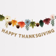 a happy thanksgiving banner with leaves and acorns hanging from it's side