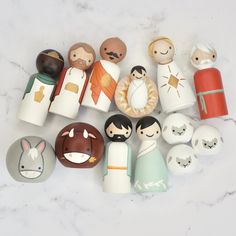 a group of wooden toy figurines sitting on top of a marble countertop