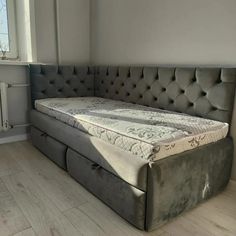 a bed that is sitting in the middle of a room next to a radiator