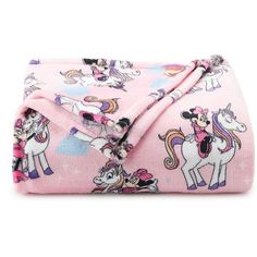 a pink blanket with unicorns on it