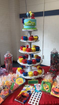 a table topped with lots of cupcakes and candy