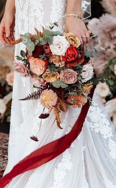 a bride holding a bouquet of flowers in her hands