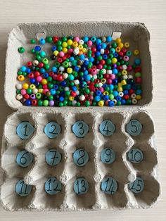 an egg carton filled with lots of colorful beads