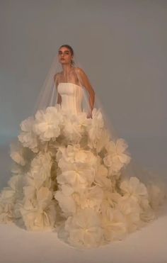 a woman in a wedding dress with flowers on it