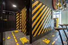 an indoor gym with yellow and black striped walls