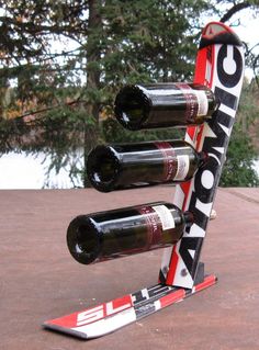 a wine rack made out of skis and bottles is shown in front of some trees