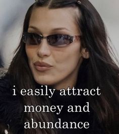 a woman wearing sunglasses with the words i easily attract money and abundance on her face