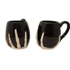 two black and white coffee mugs sitting next to each other on a white background