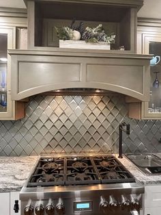 a stove top oven sitting inside of a kitchen