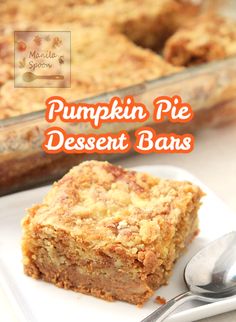 pumpkin pie dessert bars on a white plate with a spoon and glass dish in the background