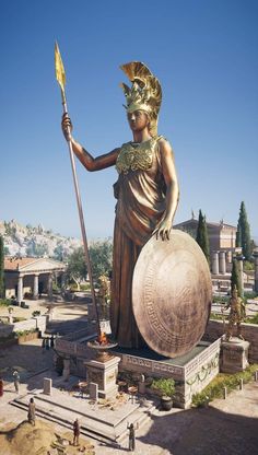 the statue is holding a spear and standing next to a large ball in front of it