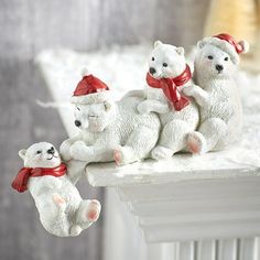 three white teddy bears sitting on top of a radiator next to each other