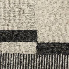 an area rug with black and white squares on the side, in various sizes and colors