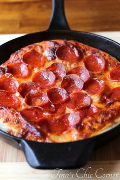 a pepperoni pizza in a cast iron skillet