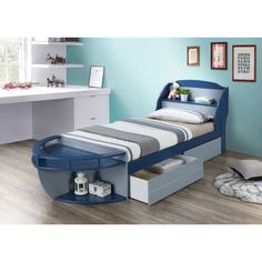 a blue bed with drawers underneath it and a desk in the corner next to it