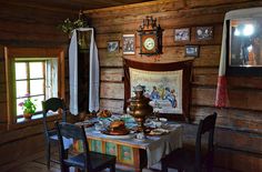 an old fashioned dining room with wooden walls