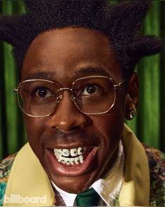 a man wearing glasses and a tie with his hair in the shape of an afro