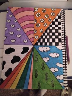 a person holding a notebook with different designs on it