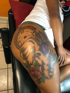 a woman sitting on top of a chair next to a clock and rose tattoo design