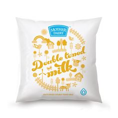 a white pillow with yellow lettering that says,'double toned milk'on it