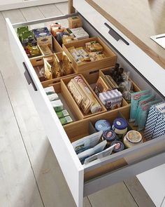 an open drawer in a kitchen filled with food