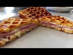 a waffle sandwich cut in half on a plate